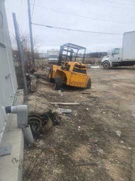 Yellow Forklift in Scrap Metal Recycling Yard