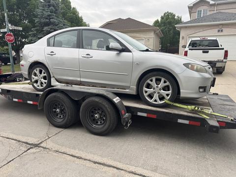 CashForCars Canada | Mazda 3 Junk Car Removal on Trailer for Scrap Metal Recycling