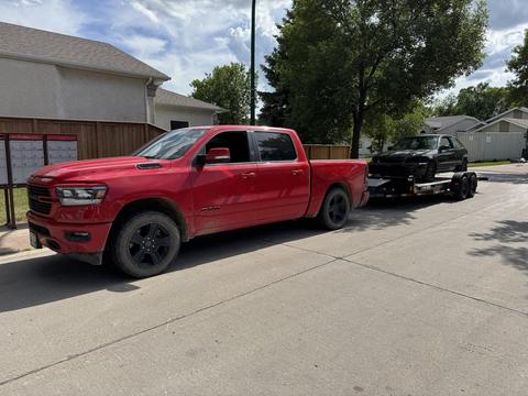 CashForCars Canada | Red Pickup Truck Towing Junk Car for Scrap Metal Recycling