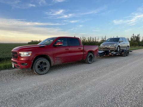 CashForCars Canada | Red Truck with Junk Car on Trailer for Recycling
